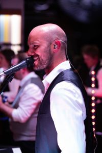 man singing with band