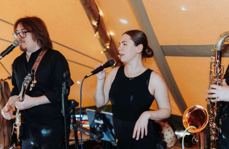 a woman singing in a band