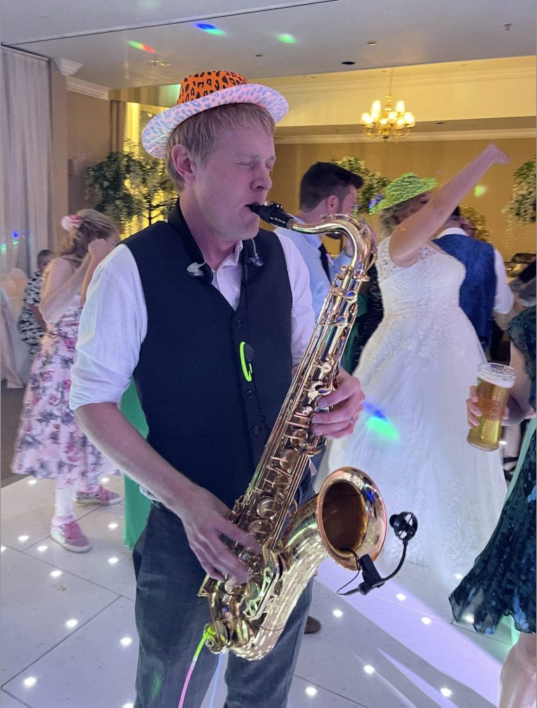 saxophone player with hat having fun on the dance floor