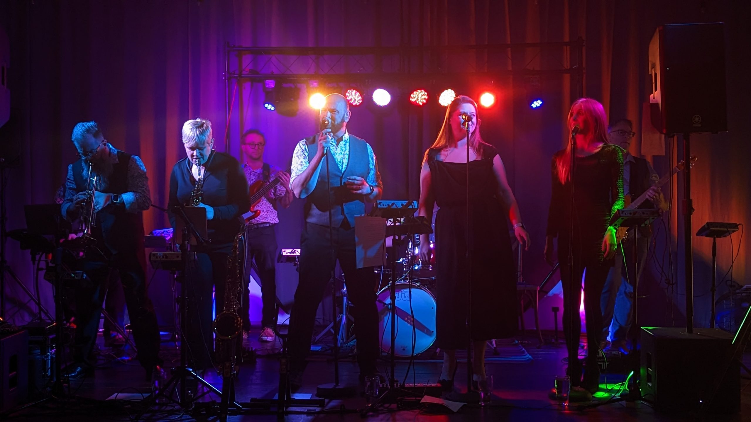 9 musicians performing on stage