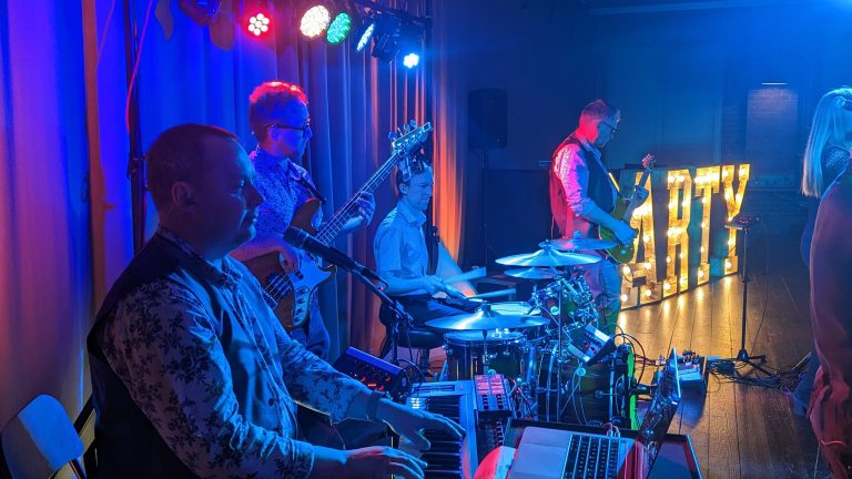 keyboard player and drummer playing music