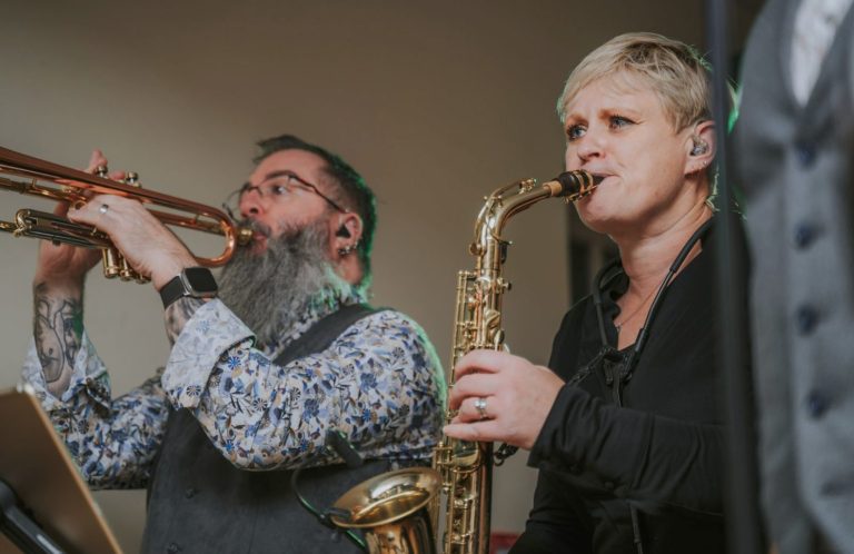 saxophone and trumpet player performing